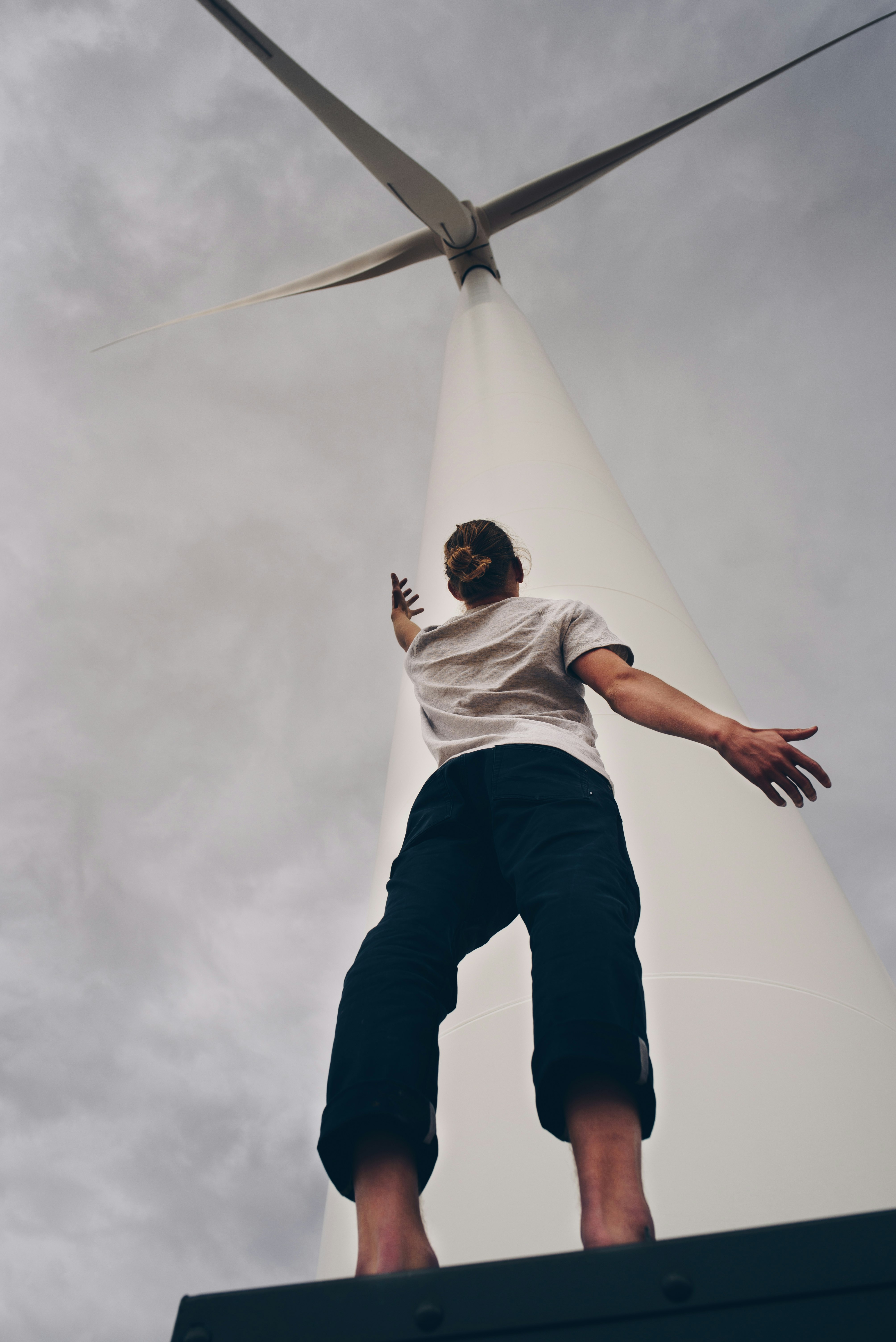 person standing on white wind mill