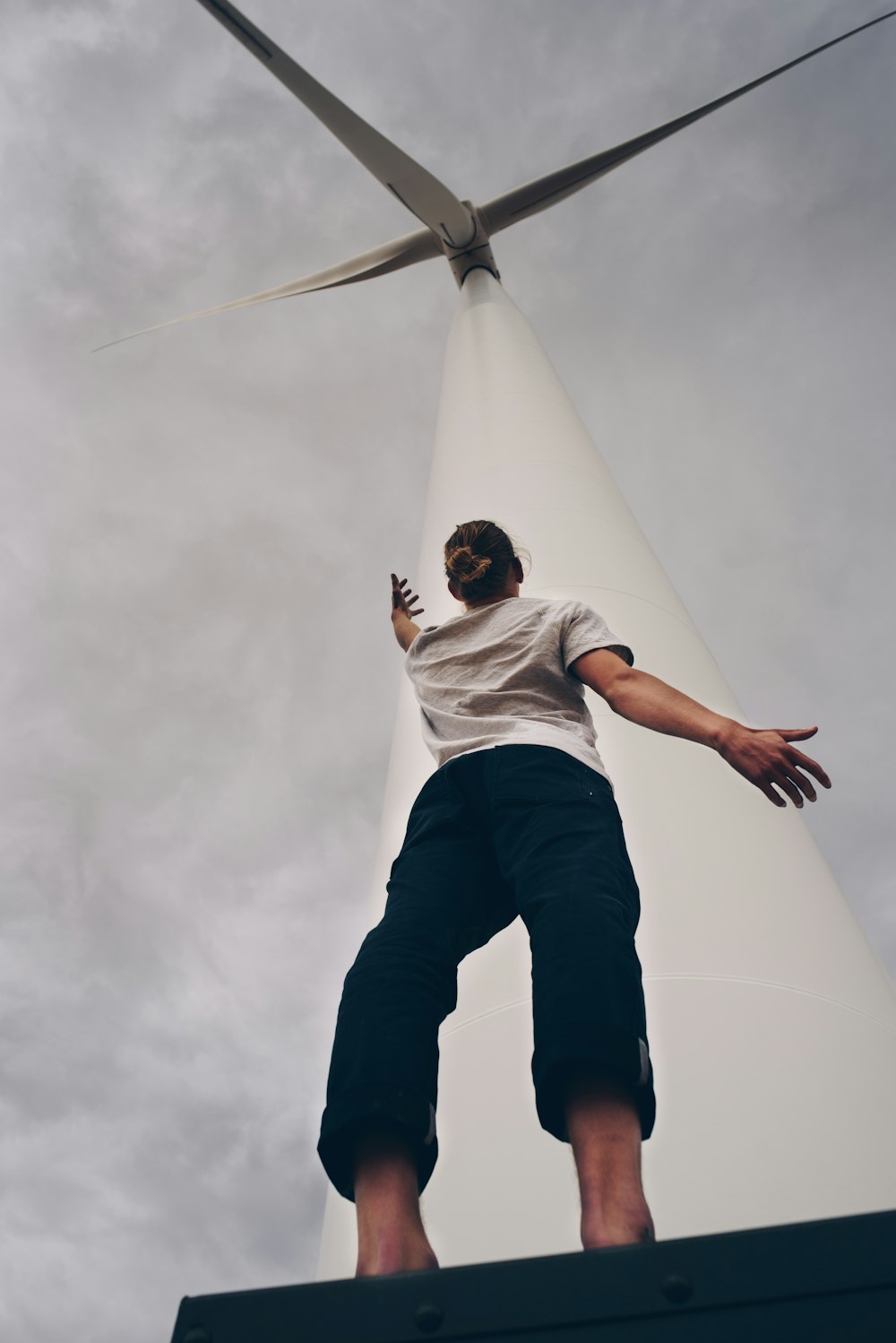 person standing on white wind mill
