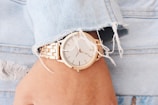 Close-up of a classic wristwatch paired with a leather jacket.