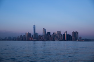 A serene urban landscape showcasing a modern city skyline at dusk with soft lighting.