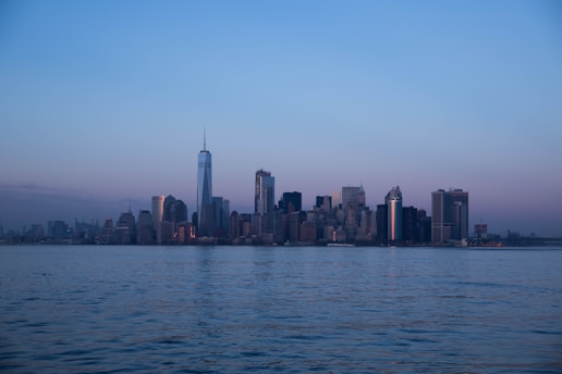 A serene urban landscape showcasing a modern city skyline at dusk with soft lighting.