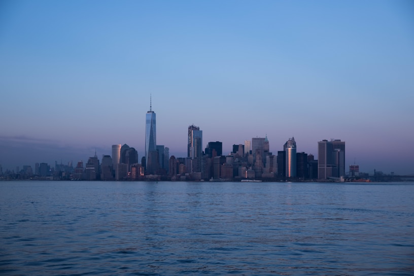 A serene urban dusk scene with soft light reflecting off glass buildings.