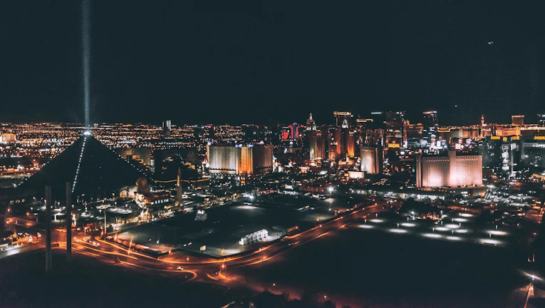 A futuristic cityscape of Monterrey at dusk with glowing neon lights.
