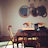 A cozy dining area featuring a handcrafted wooden table and chairs bathed in warm natural light.