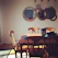 A cozy dining area featuring a handcrafted wooden table and chairs bathed in warm natural light.