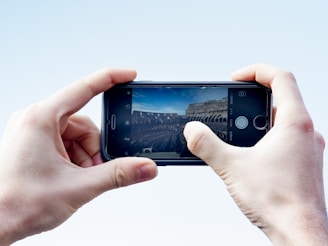 Travelers capturing photos in front of iconic landmarks under a clear blue sky.