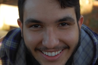 Close-up of Anurag smiling confidently while reviewing his fantasy game lineup.