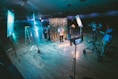 man standing in front of cameras with string lights background