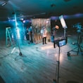 man standing in front of cameras with string lights background