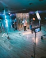 man standing in front of cameras with string lights background