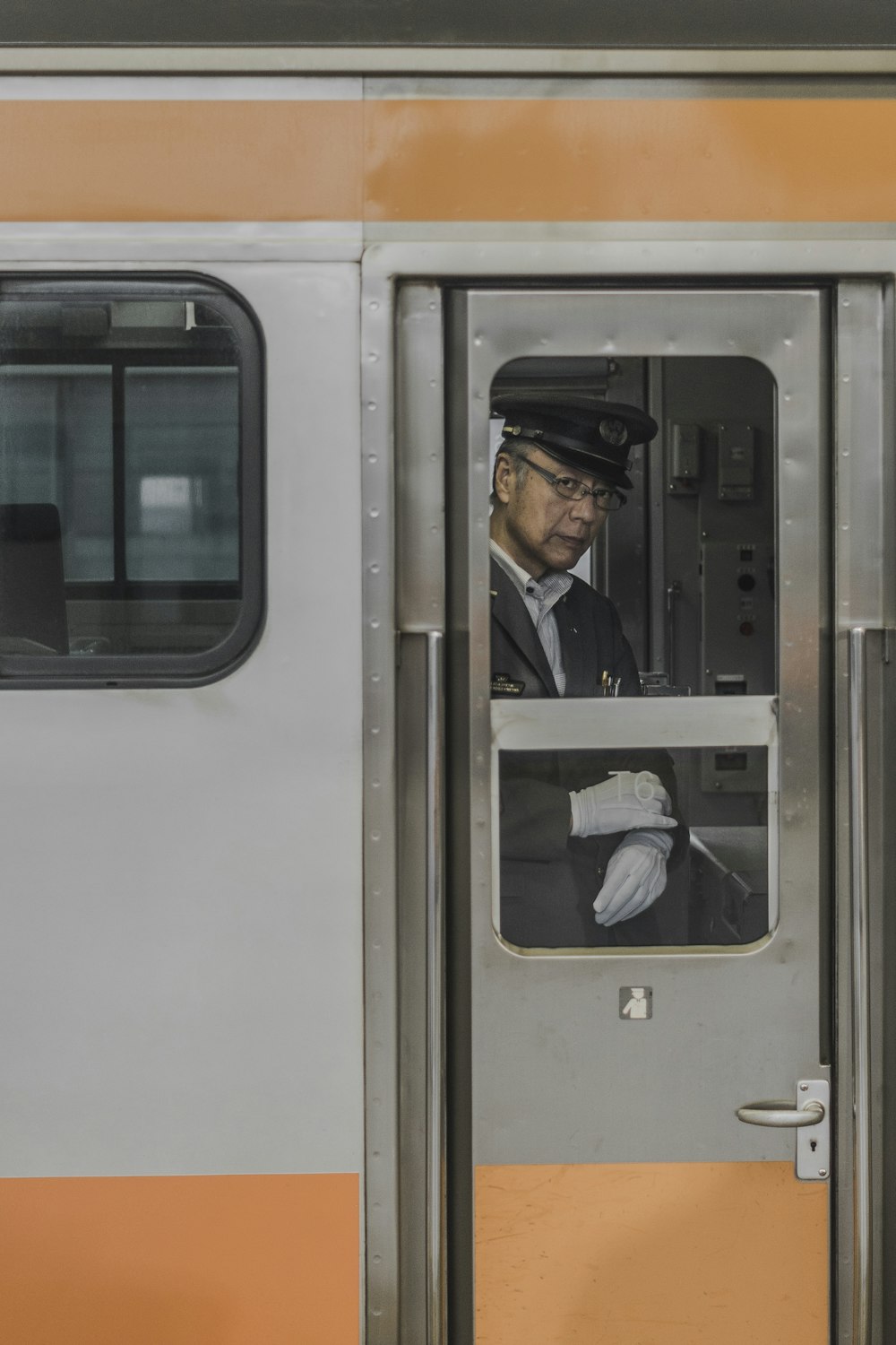 man wearing suit jacket inside train