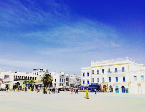 A bustling plaza in San Vicente del Caguán with shoppers enjoying local stores under a bright sky.