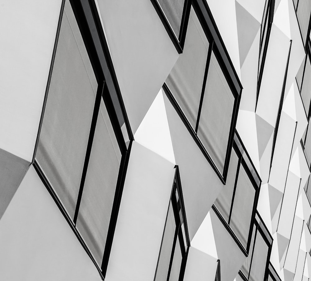 a black and white photo of windows on a building