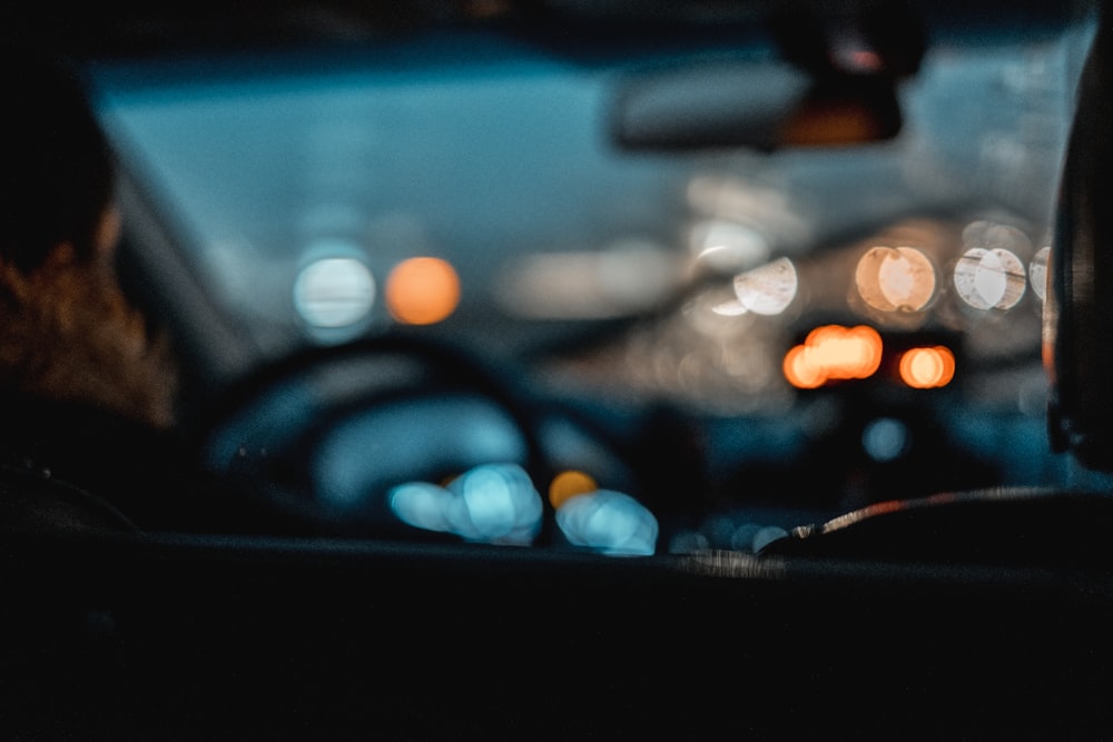 Blurred POV shot from inside a vehicle with moving wipers.