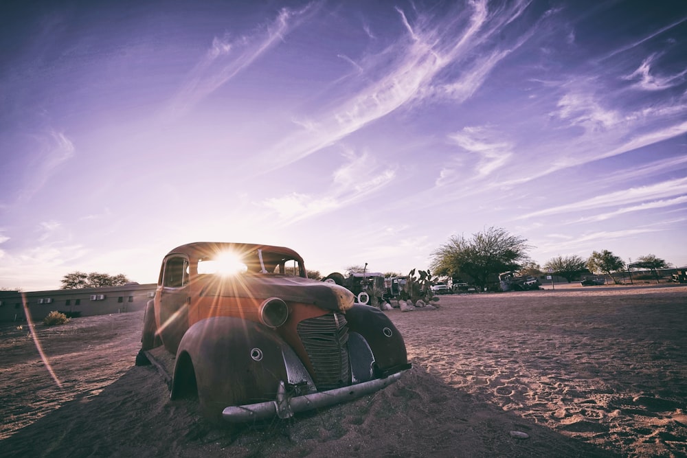 brown vehicle on sand during daytime