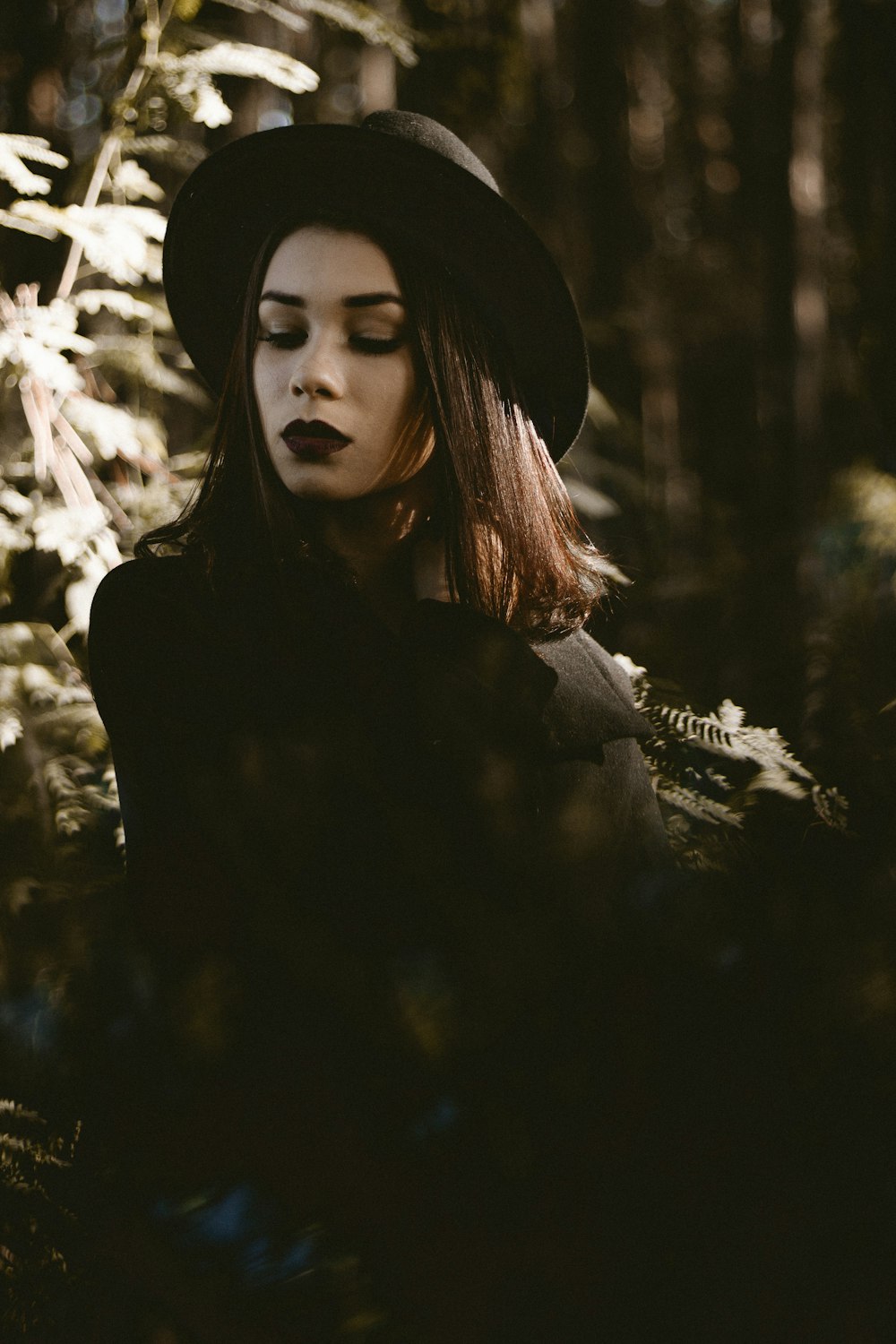 woman standing near leafed tree