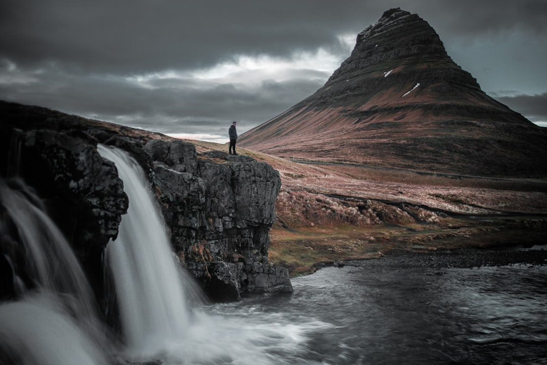 Iceland highlands landscape with mountain waterfall and man - Photo by Martin Jernberg | best digital marketing - London, Bristol and Bath marketing agency