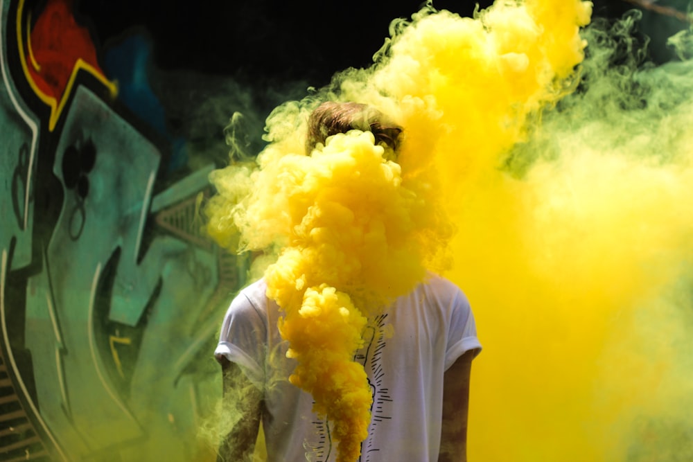 Yellow smoke coming from a tagger's spray paint can.