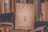 A vintage journal titled 'Logos Revista de la Facultad de Filosofía y Letras' is prominently placed among a collection of various books on a cluttered shelf. The worn, yellowed cover contains textual elements and an illustration of a bearded figure. The surrounding books have colorful but faded covers, contributing to a nostalgic and scholarly atmosphere.