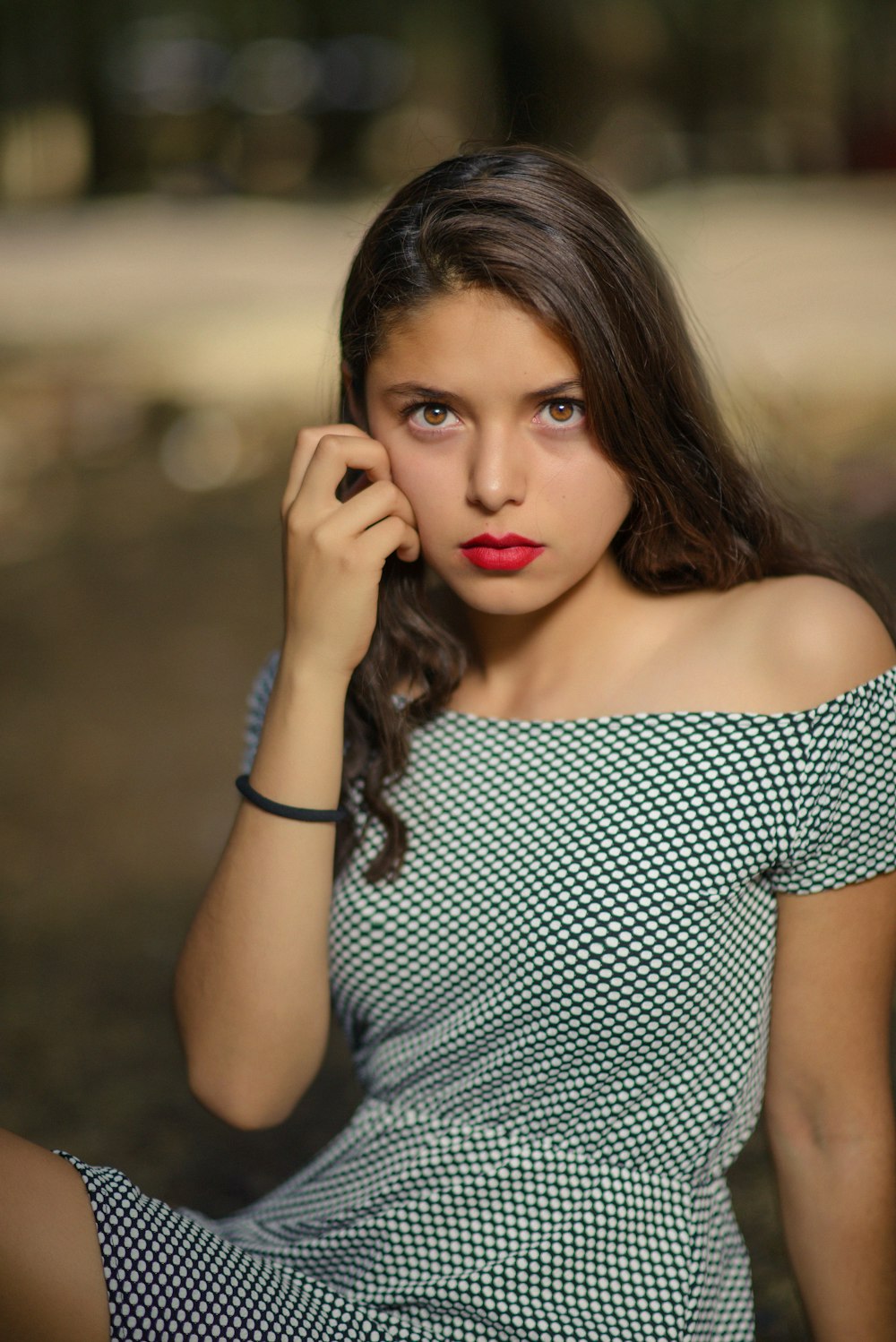 woman in black and white polka dot off shoulder dress