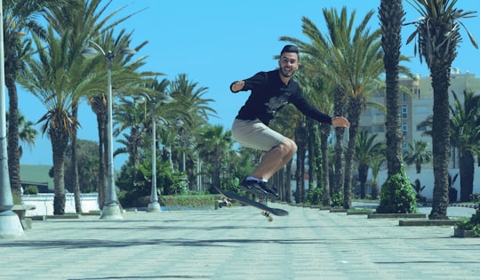 man in black jacket and black pants riding skateboard during daytime in Asilah Morocco
