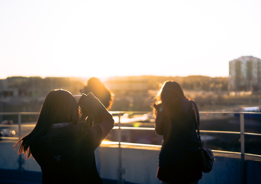 woman taking photo of another woman