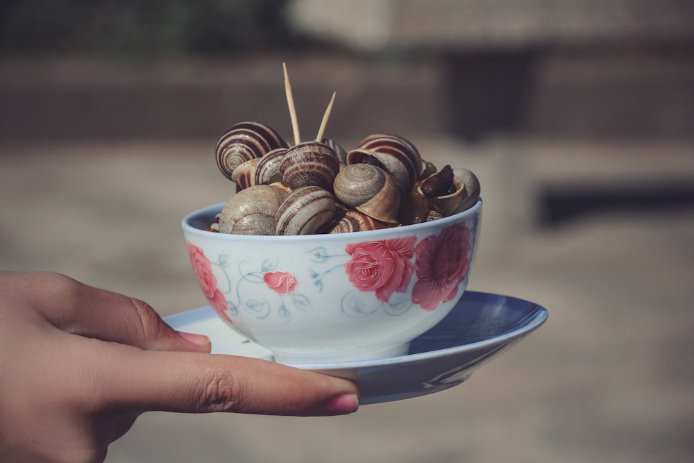 brown and white round fruit in white ceramic bowl