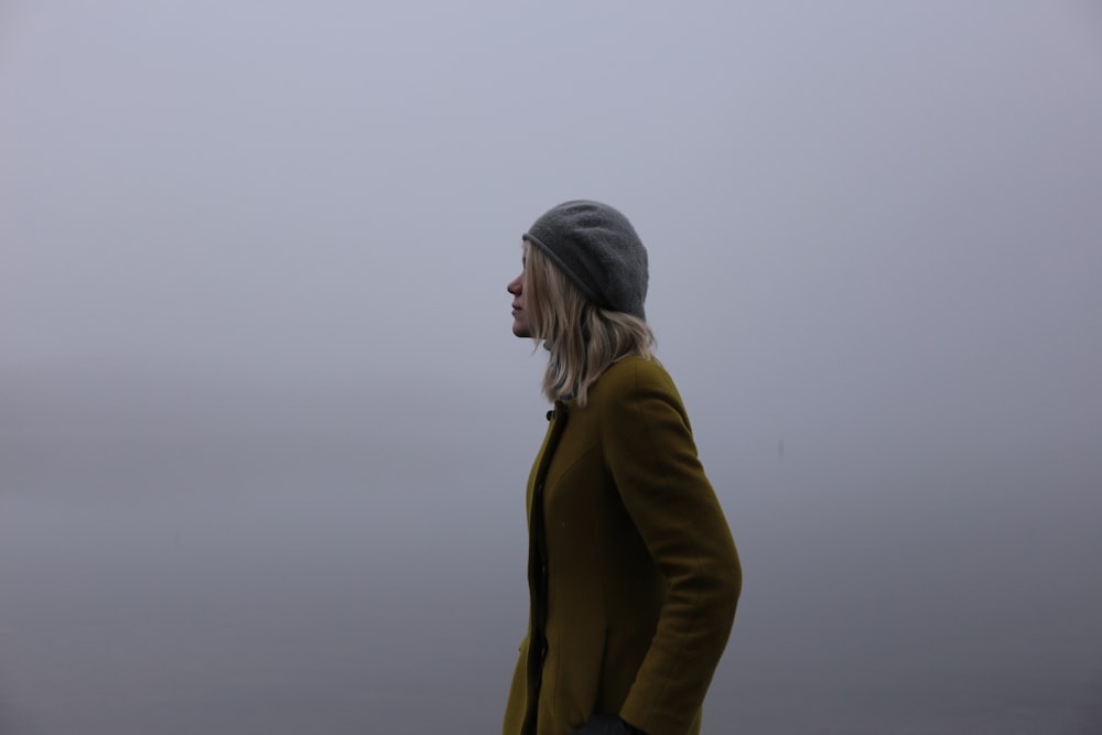 woman in olive-green jacket and gray hat