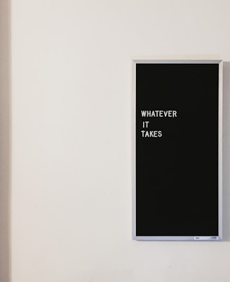 gray metal framed chalkboard with whatever it takes written