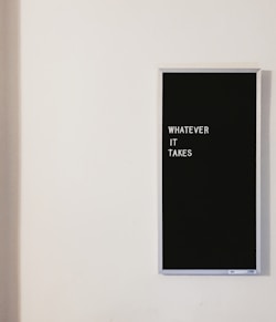 gray metal framed chalkboard with whatever it takes written