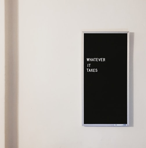 gray metal framed chalkboard with whatever it takes written