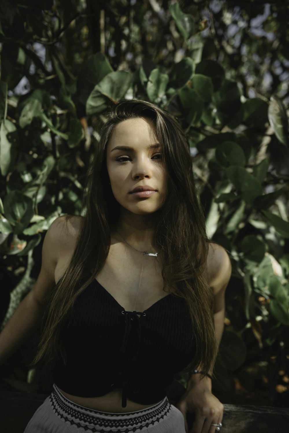 lowlight photography of woman in black crop top near plants