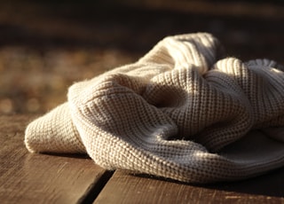 white textile on wooden plank