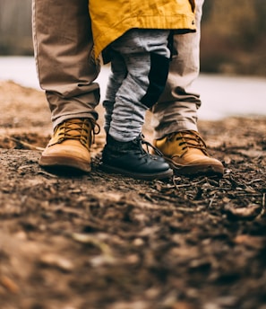 two person step on gray soil