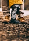 two person step on gray soil