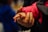 A close-up shot of a person's hand gently holding a child's hand. The child is wearing a bright pink jacket, and the adult's hand appears protective and caring.