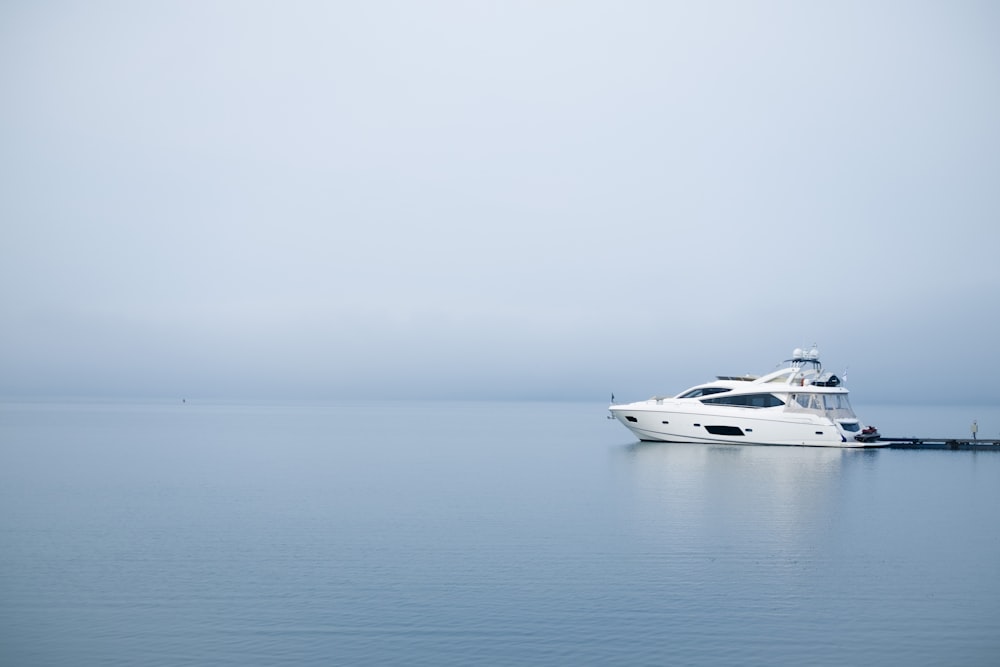 white yacht on body of water