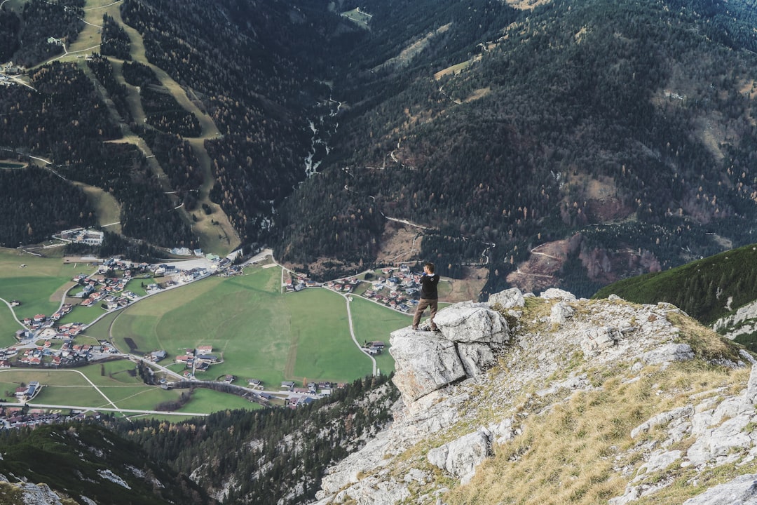 person standing on rock formation during daytime