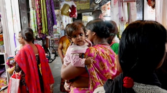 Photo of the Kasam Sambamurthy Sarees store front in Warangal with vibrant sarees displayed.