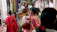 A family happily exploring a vibrant market in an Indian city.