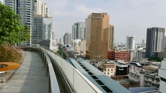 Modern city apartment with a balcony view of skyscrapers and bustling streets below.