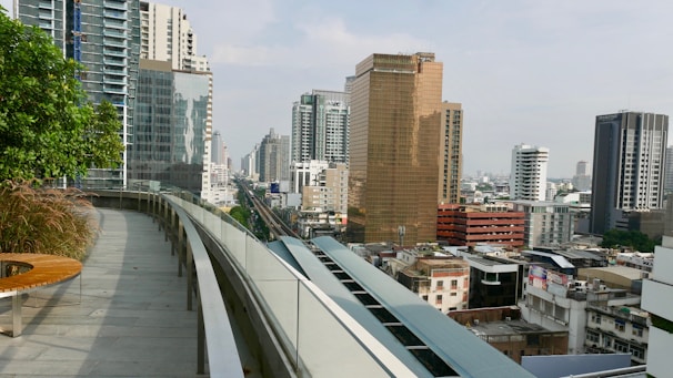 Modern city apartment with a balcony view of skyscrapers and bustling streets below.