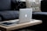 A sleek laptop displayed on a stylish table with accessories around it.