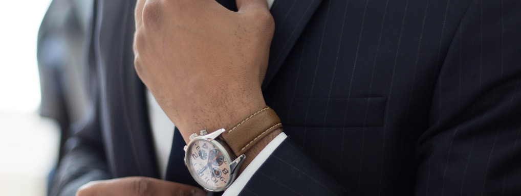 man wearing watch with black suit