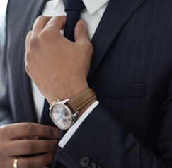 man wearing watch with black suit