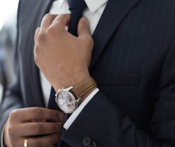 man wearing watch with black suit