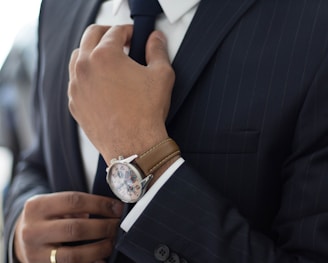 man wearing watch with black suit