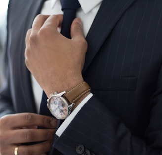 man wearing watch with black suit