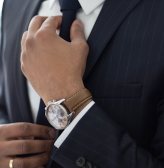 man wearing watch with black suit