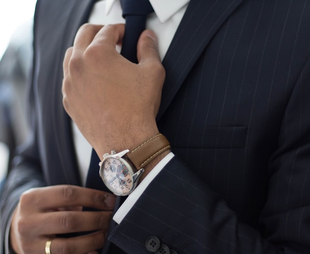 man wearing watch with black suit